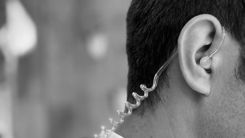 Close personal protection officer wearing a discreet earpiece