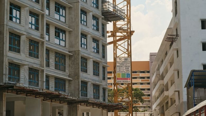 Multi-storey construction site with tower crane secured against theft and vandalism