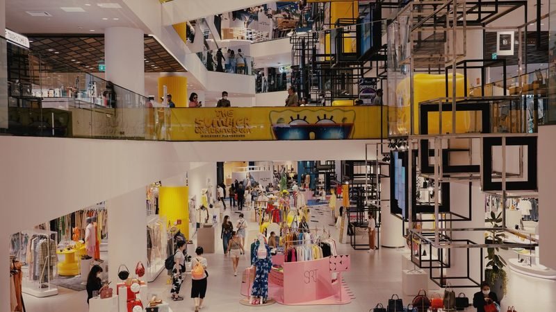 Busy shopping centre interior monitored by retail loss prevention officers